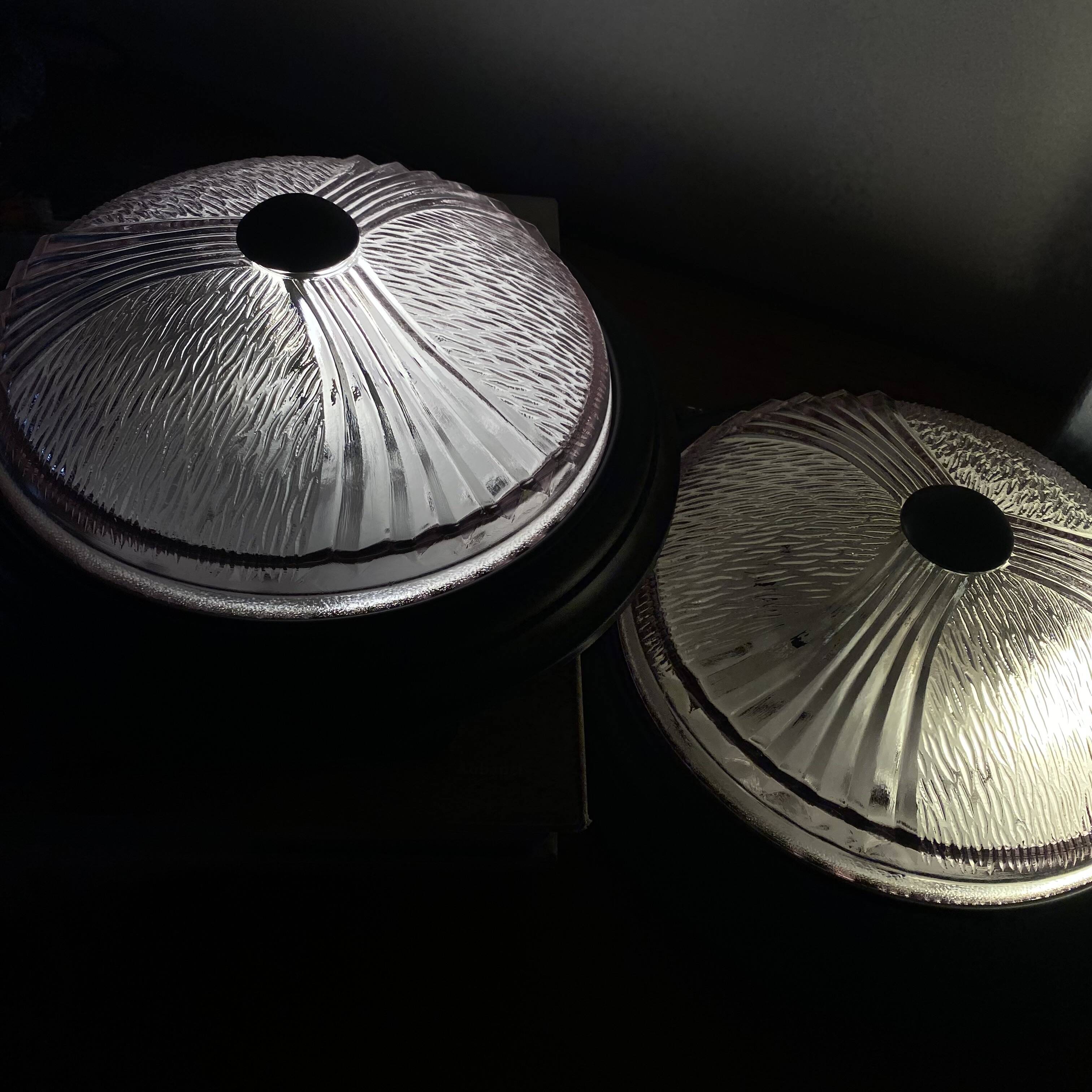 Pair of slightly pink glass ceiling lights and vintage black metal.