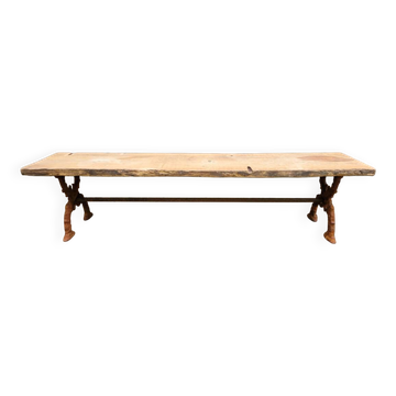 French country-style cast iron garden bench with old barn wood plank.