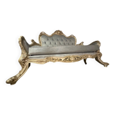 A soft light blue and silver tufted beechwood sofa in the Louis style
