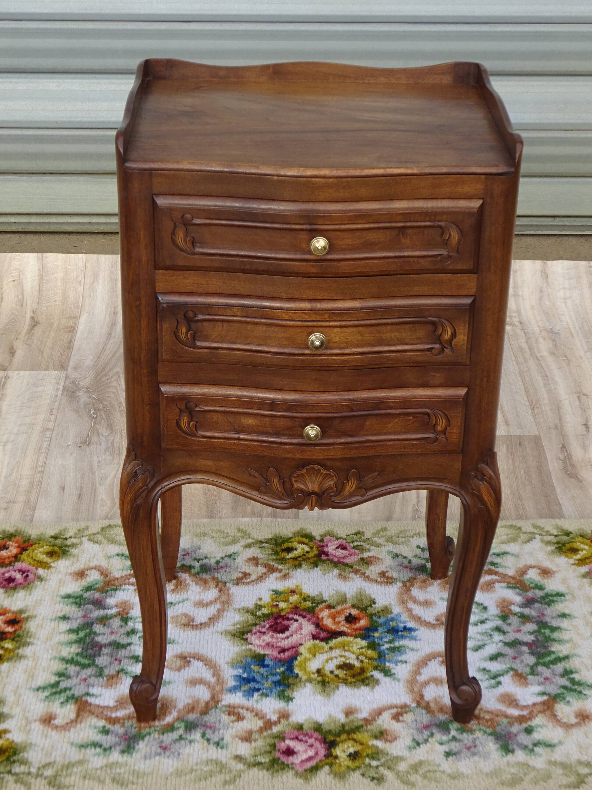 Louis XV bedside table in walnut, 3 drawers, raised edges on the tops.