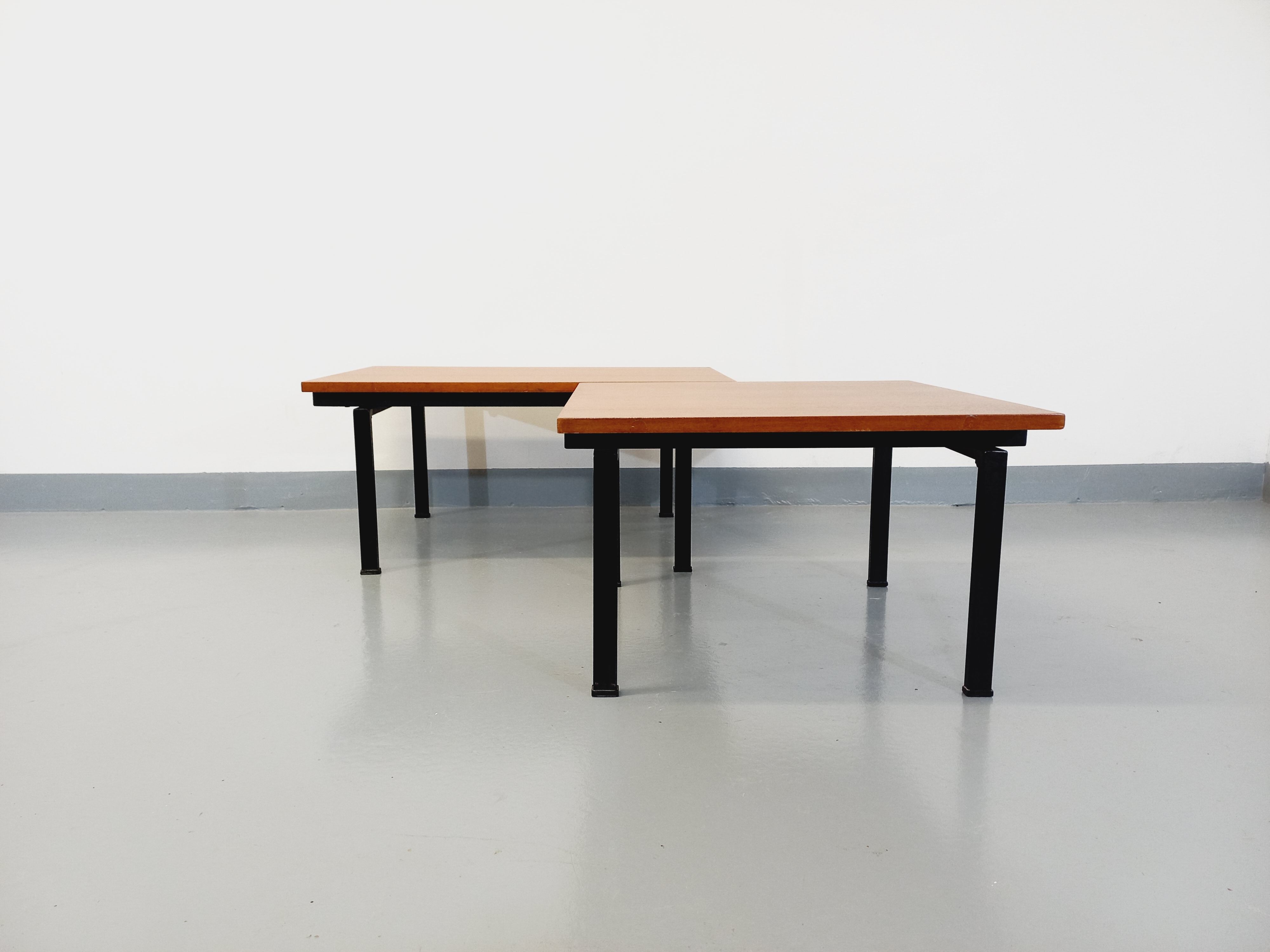 Suite of two vintage modernist Isa coffee tables in teak and black metal from the 60s