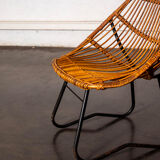 Rattan armchair with metal legs