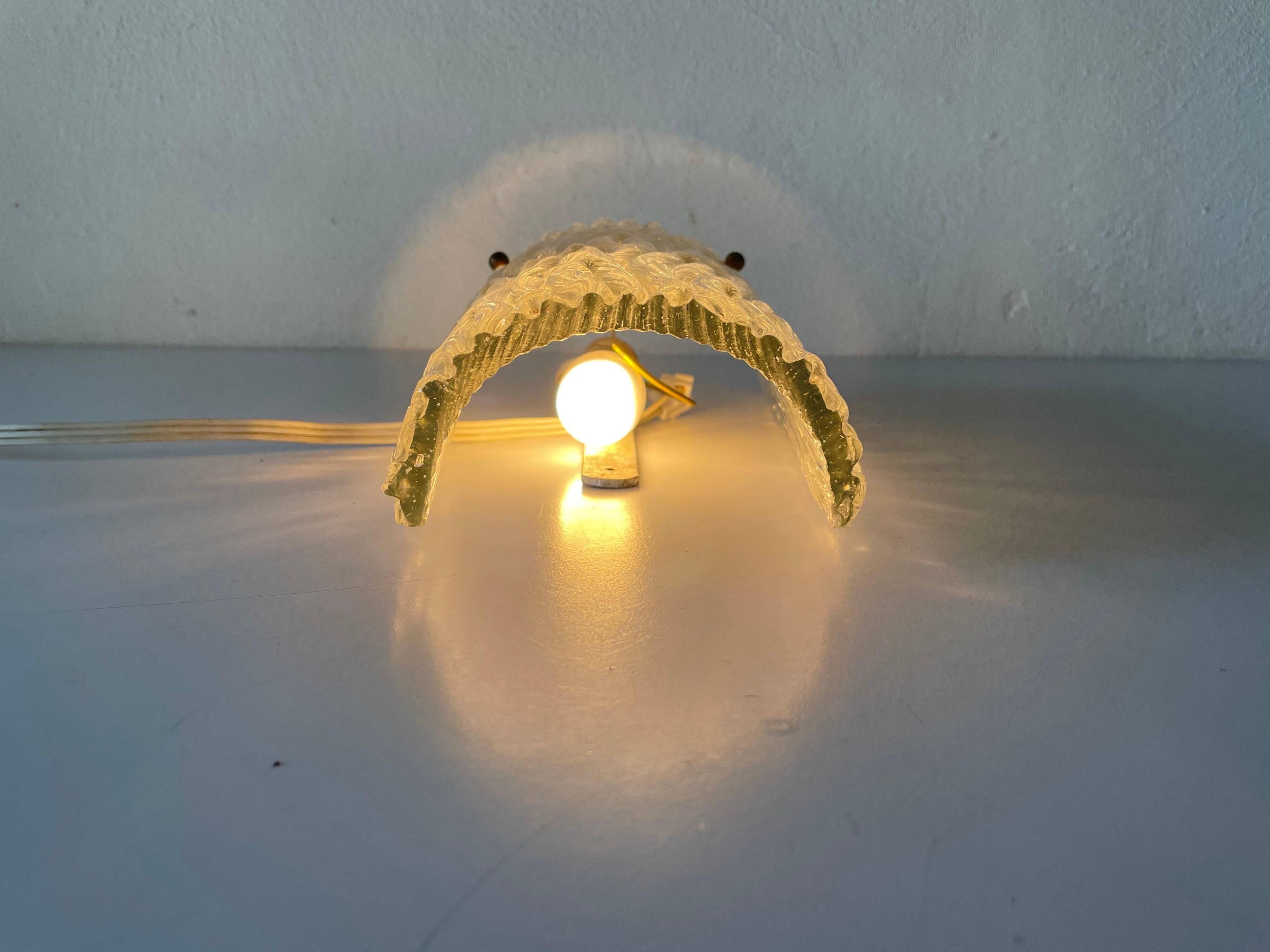 Simple arch-shaped wall light in textured glass, 1950s, Germany.