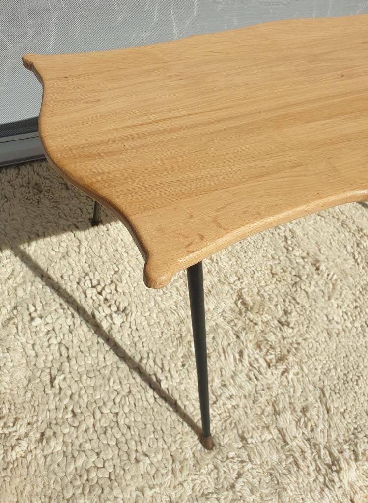 Violin-shaped coffee table with brass legs