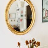 Oval wall mirror in gilded wood