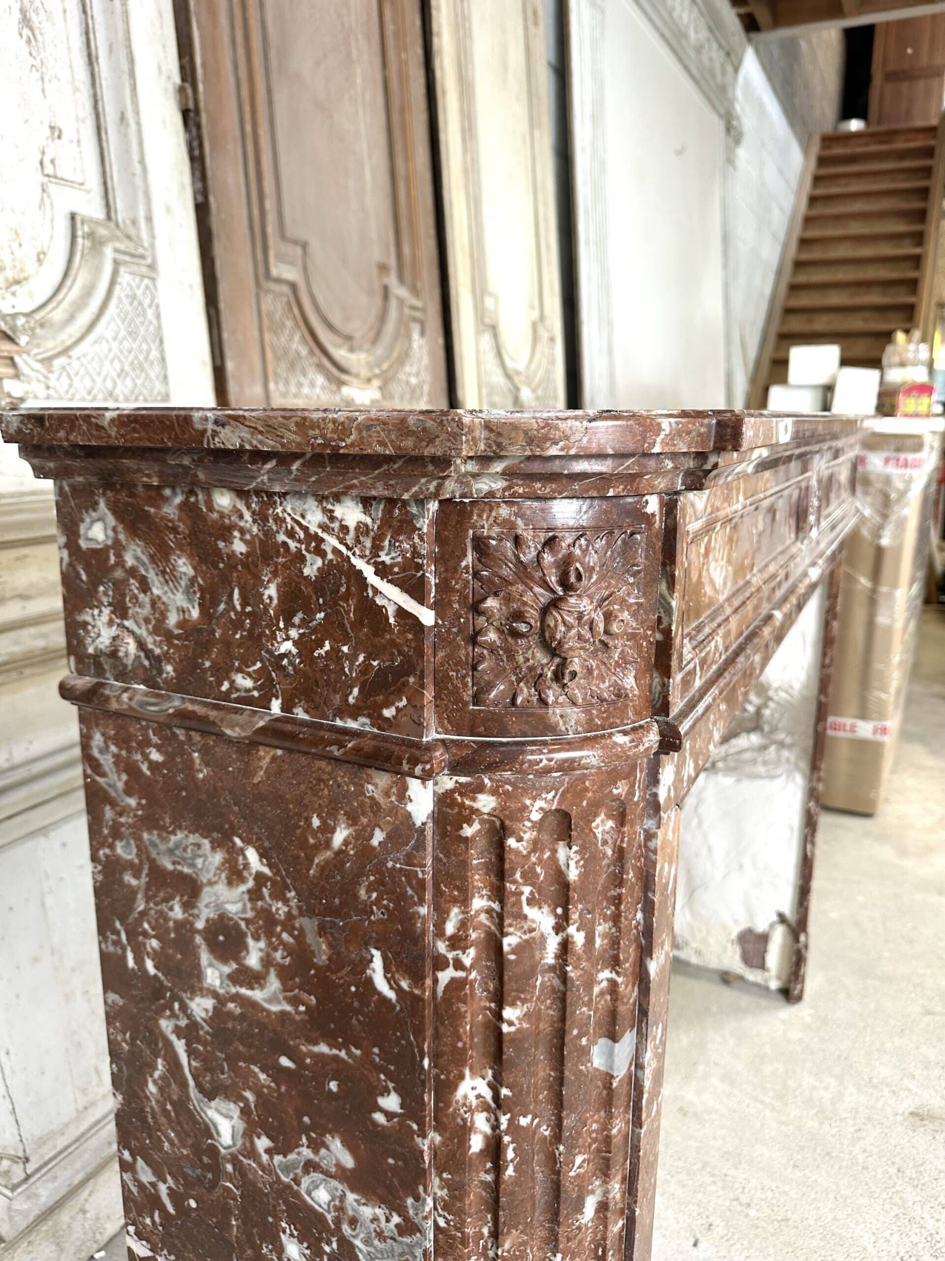 Red marble fireplace in the Louis XVI style, late 19th century