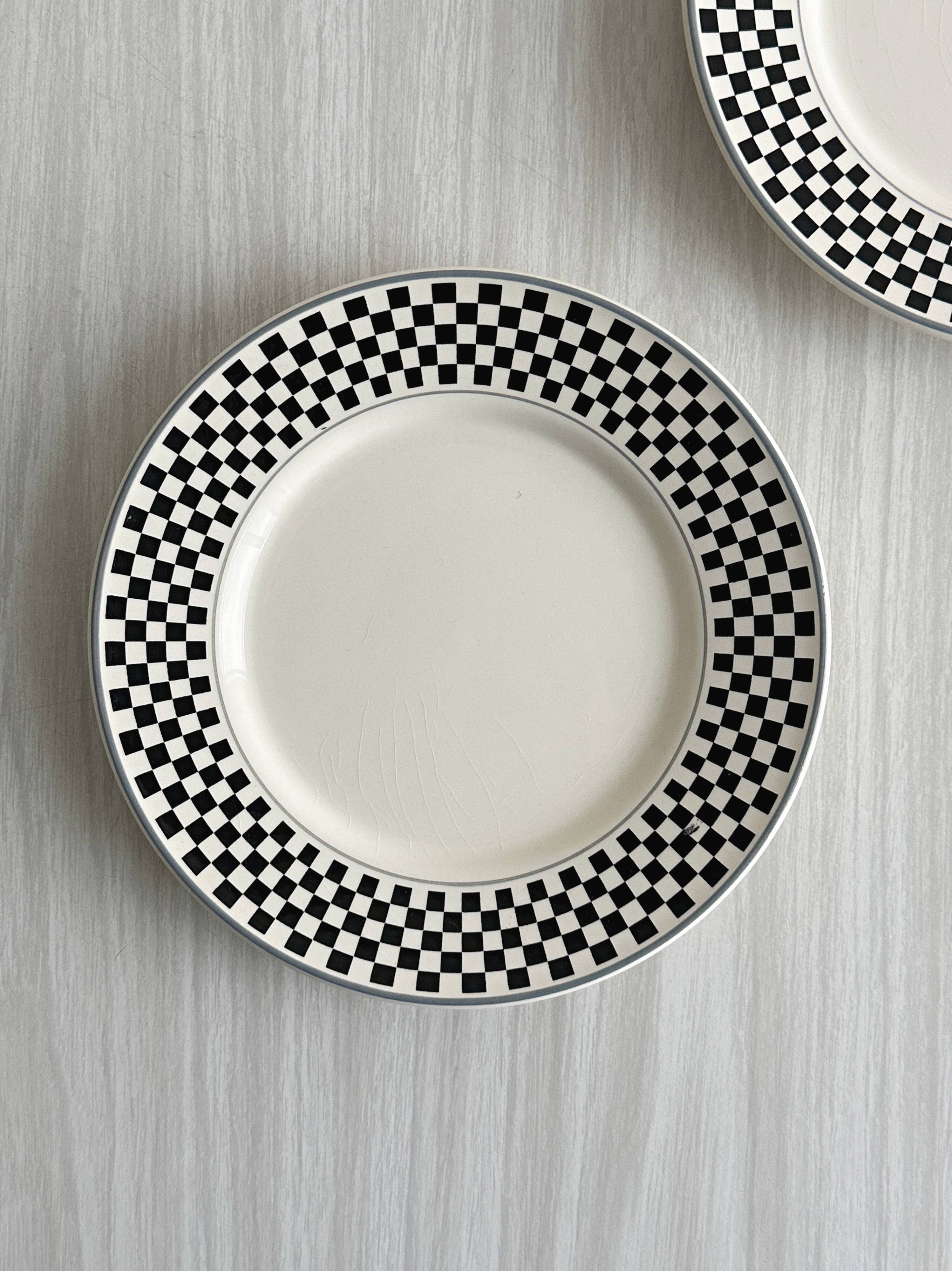 Pair of vintage plates with a black and white checkered pattern.