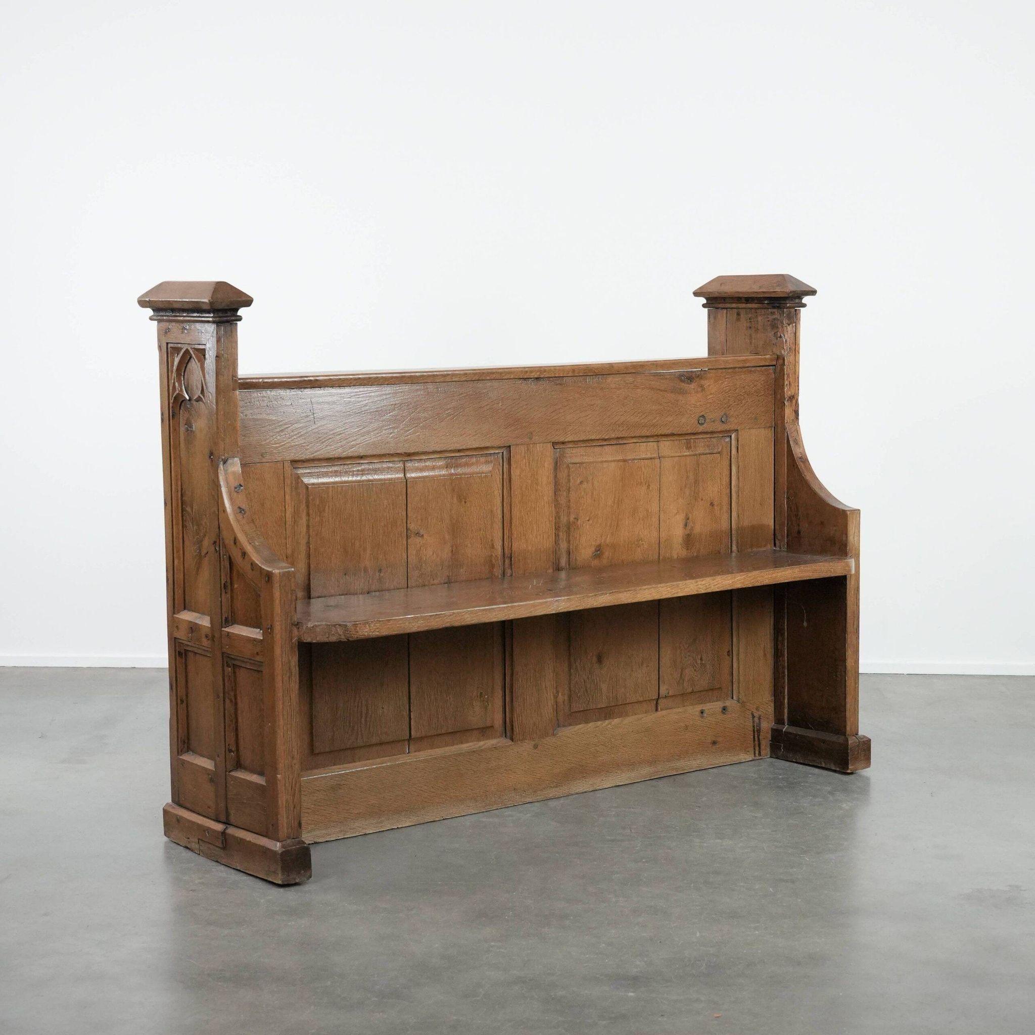 Antique oak church bench in Gothic style with beautiful wood carving