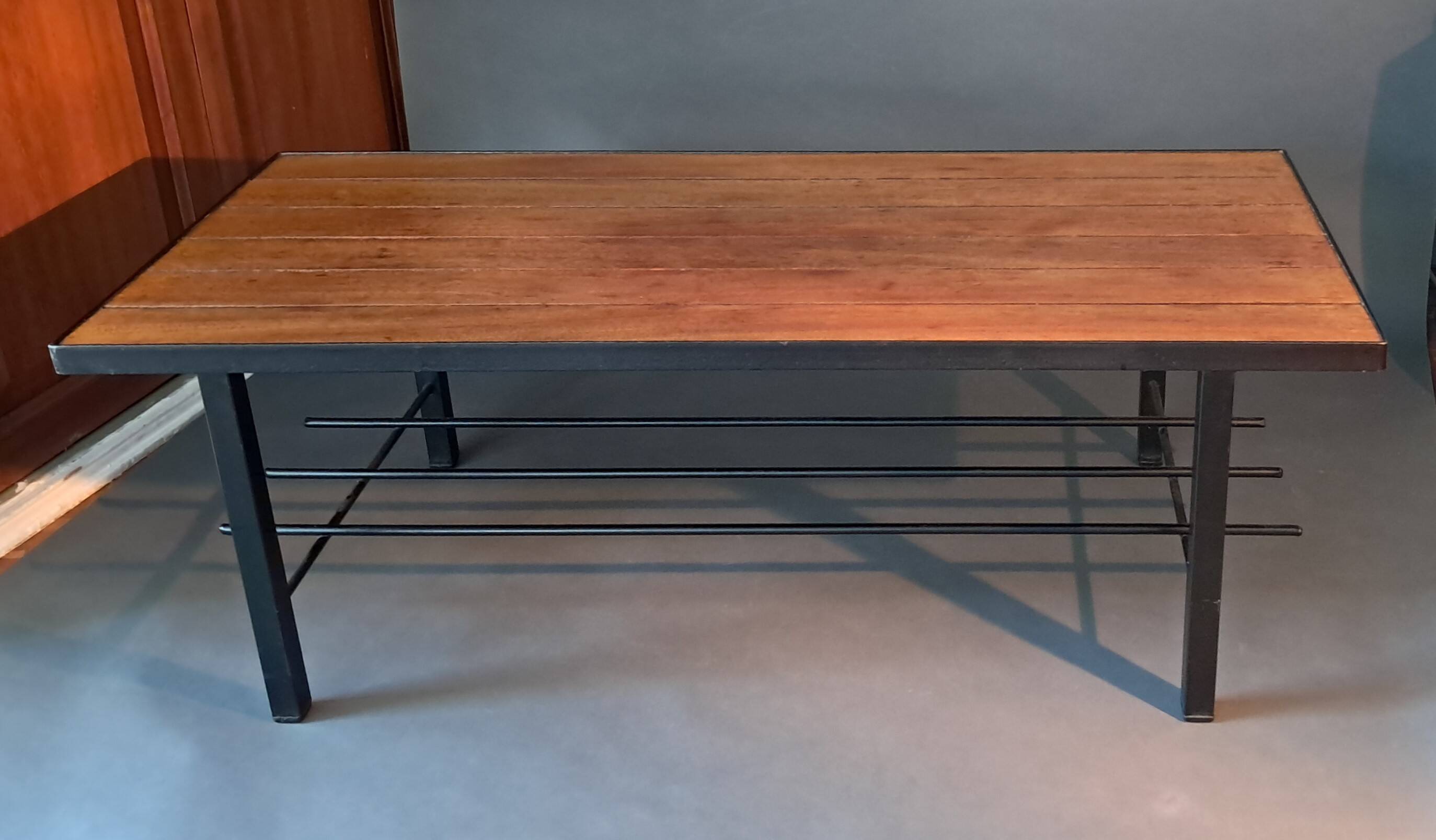 Vintage modernist coffee table in teak and black metal.