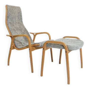 Vintage Swedese Lamino armchair and grey sheepskin footrest.