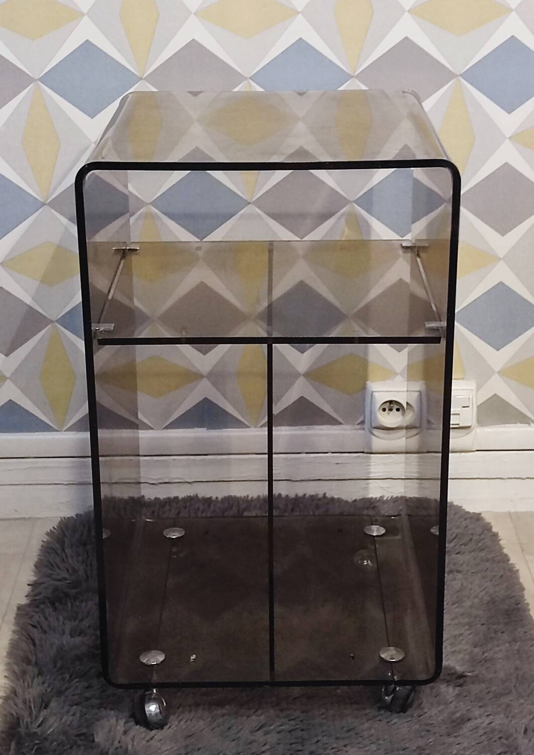 Michel Dumas smoked Plexiglas rolling table.