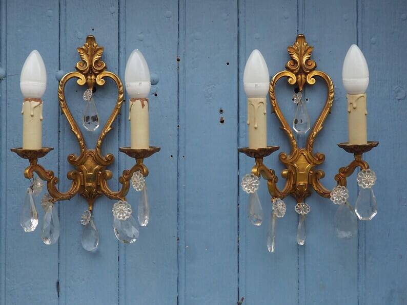 French antique Louis XV style twin arm wall sconces in bronze with crystals.