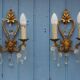 French antique Louis XV style twin arm wall sconces in bronze with crystals.