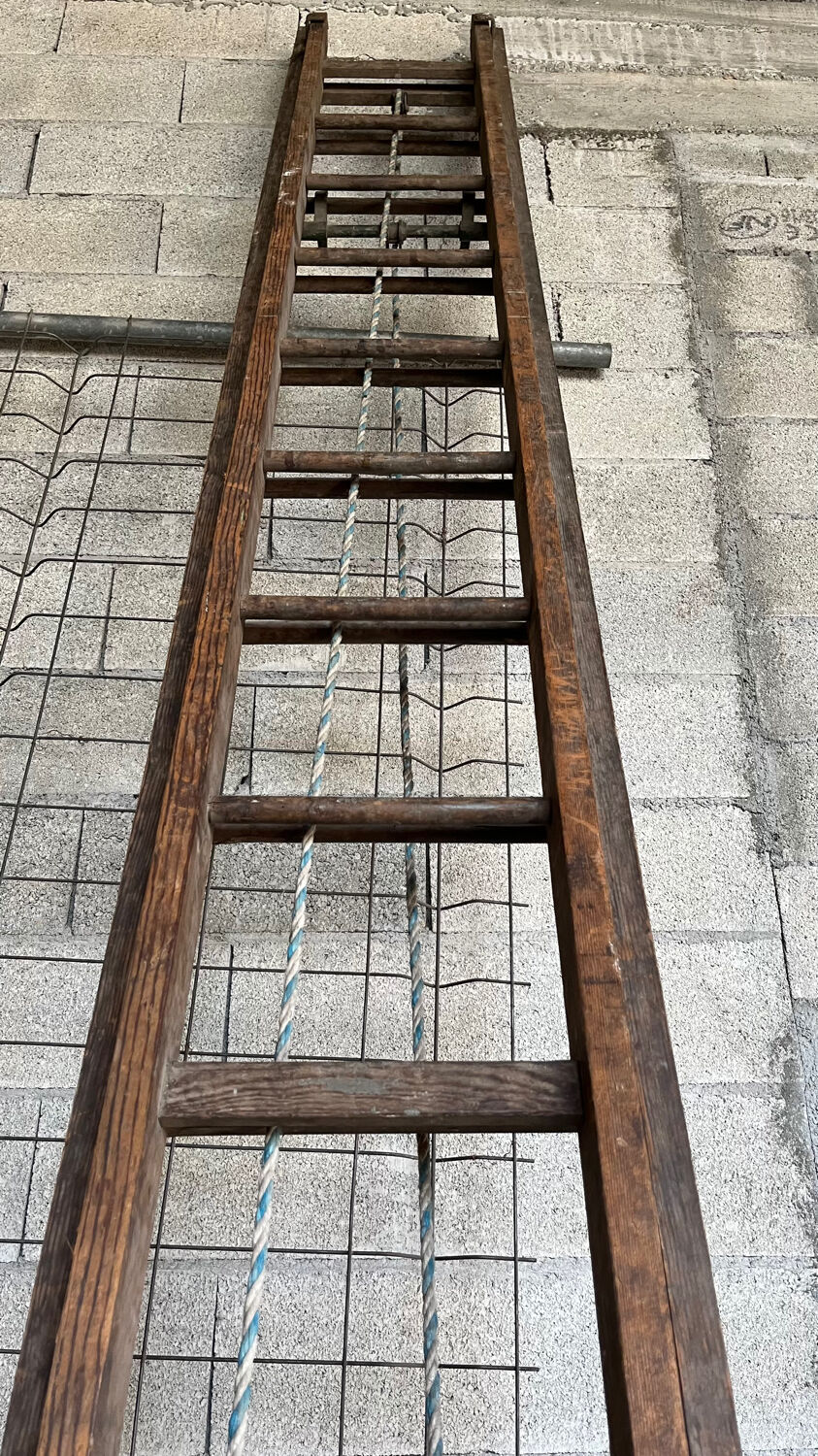 Very large vintage sliding wooden ladder