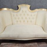 Banquette vintage à dossier capitonné, revêtu d’un tissu ivoire