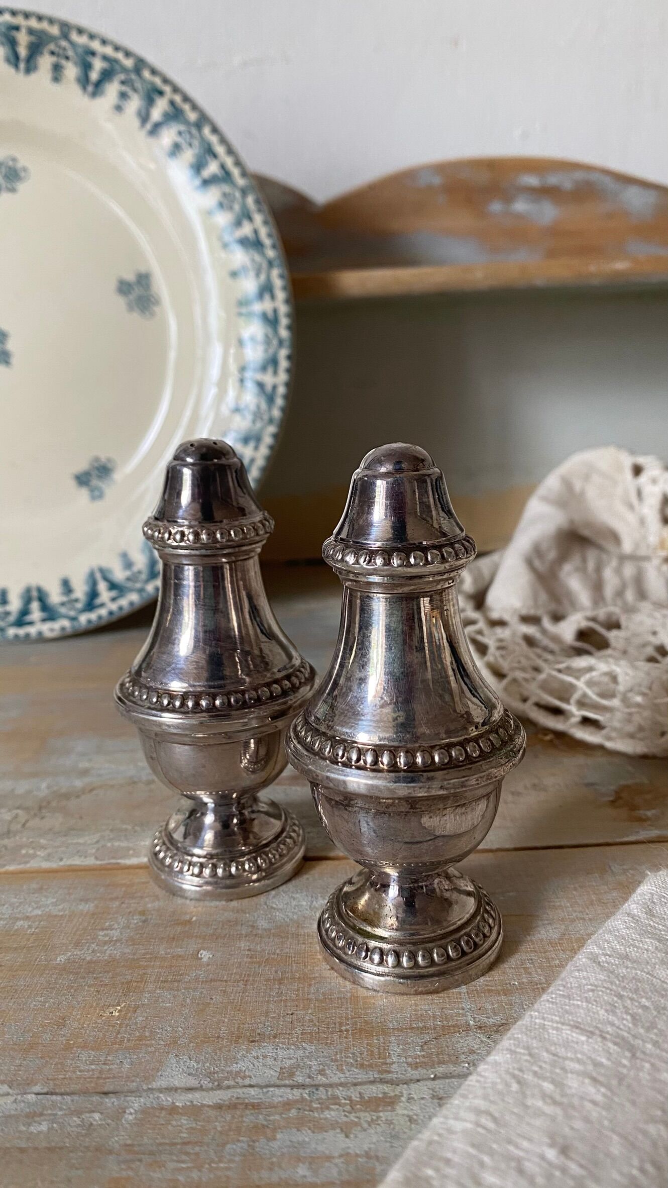 Silver-plated salt and pepper shakers, fluted, beaded decoration.