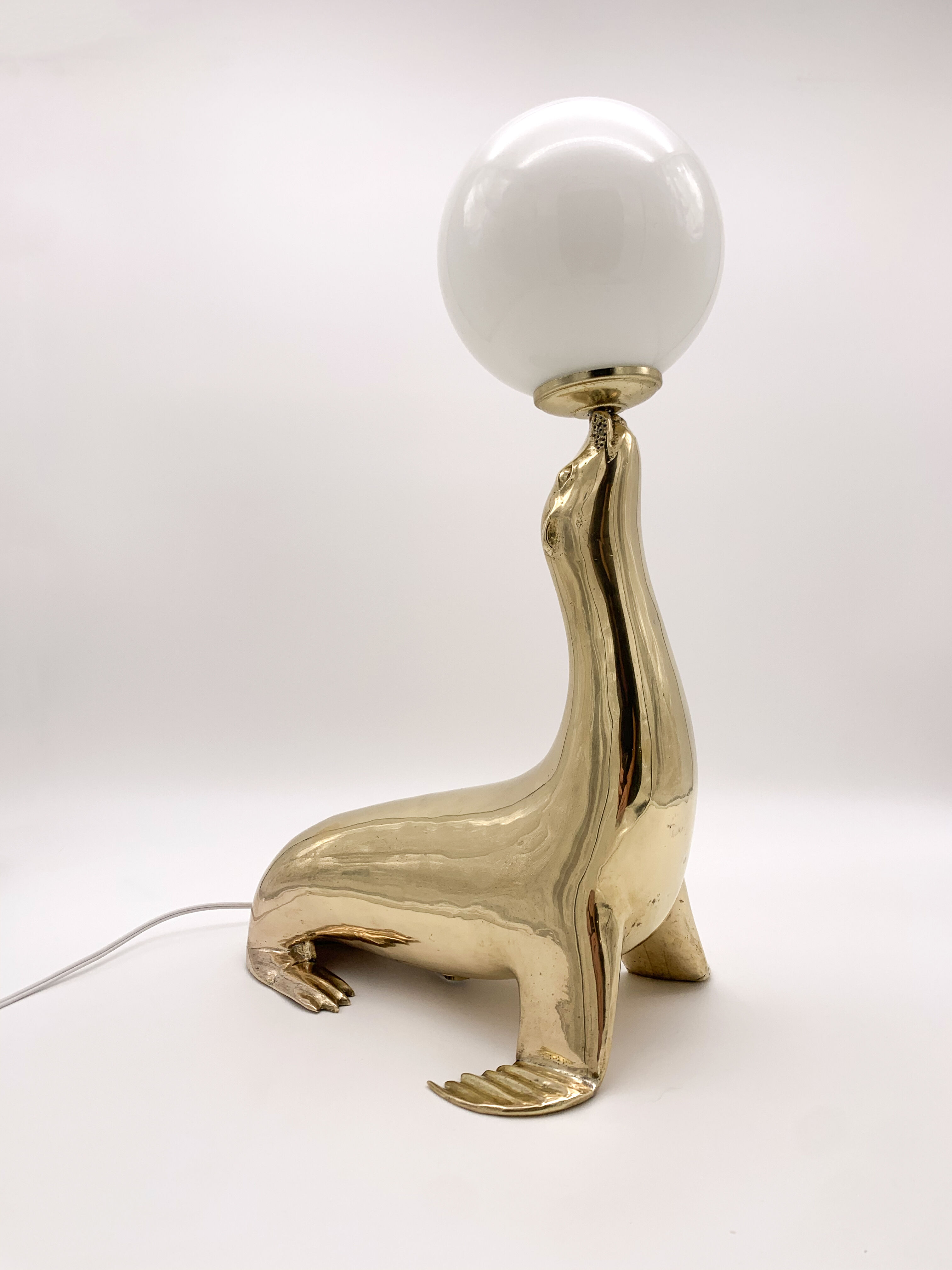 Vintage brass sea lion lamp