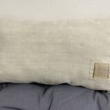 Cushion in vintage fabric with ornamentation