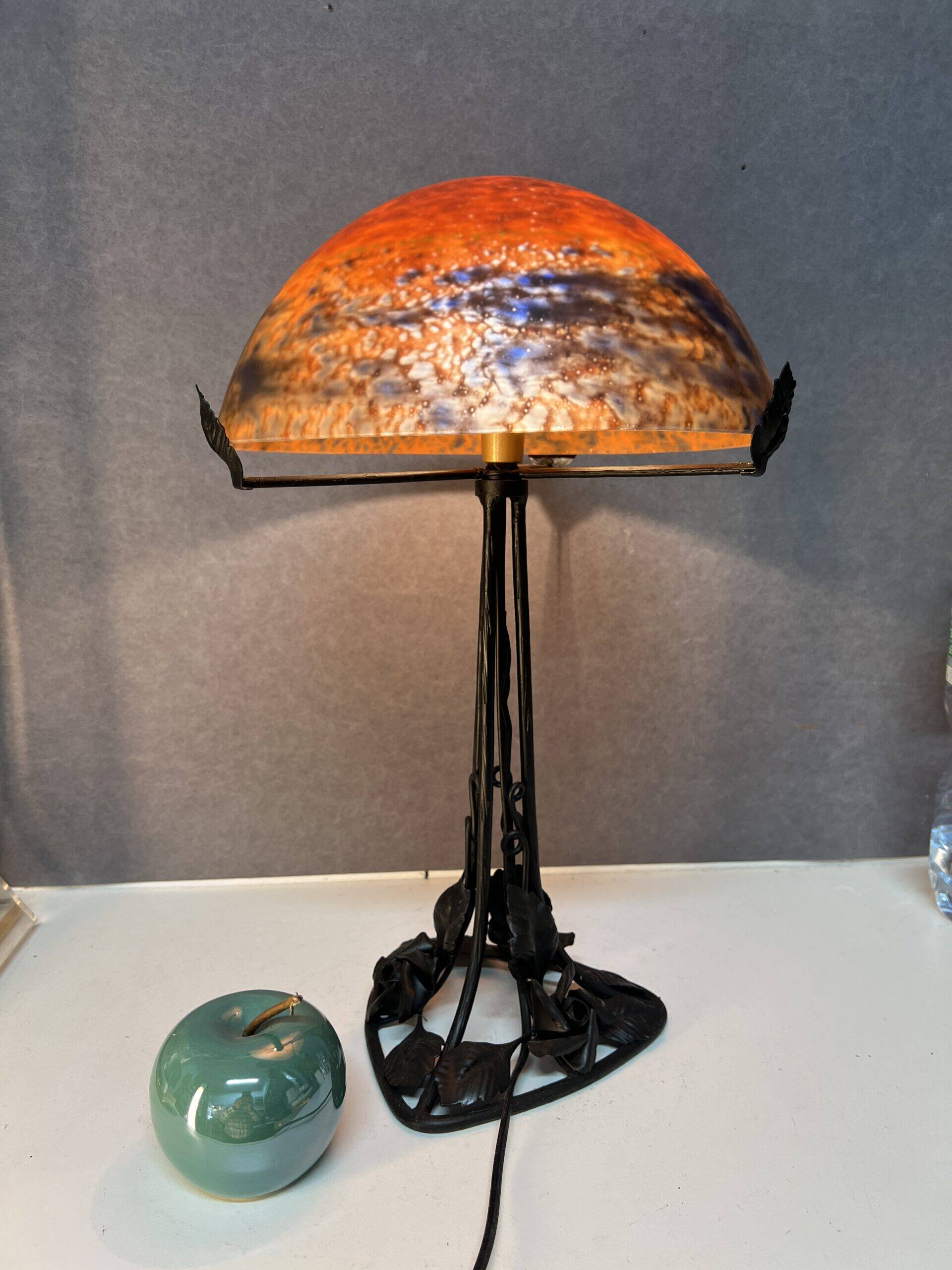 Contemporary mushroom lamp, wrought iron base and shaded orange glass shell