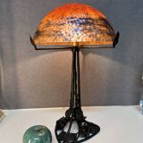 Contemporary mushroom lamp, wrought iron base and shaded orange glass shell