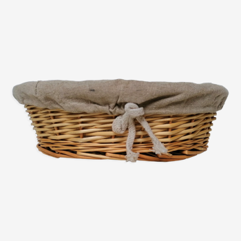 Braided rattan pan-maker bread basket covered with linen fabric