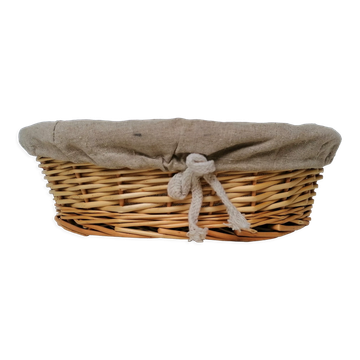 Braided rattan pan-maker bread basket covered with linen fabric