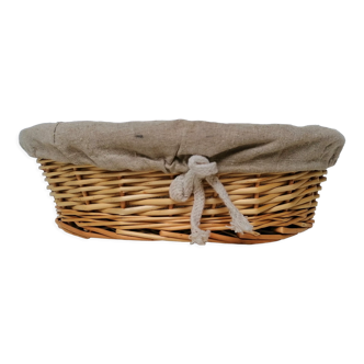 Braided rattan pan-maker bread basket covered with linen fabric