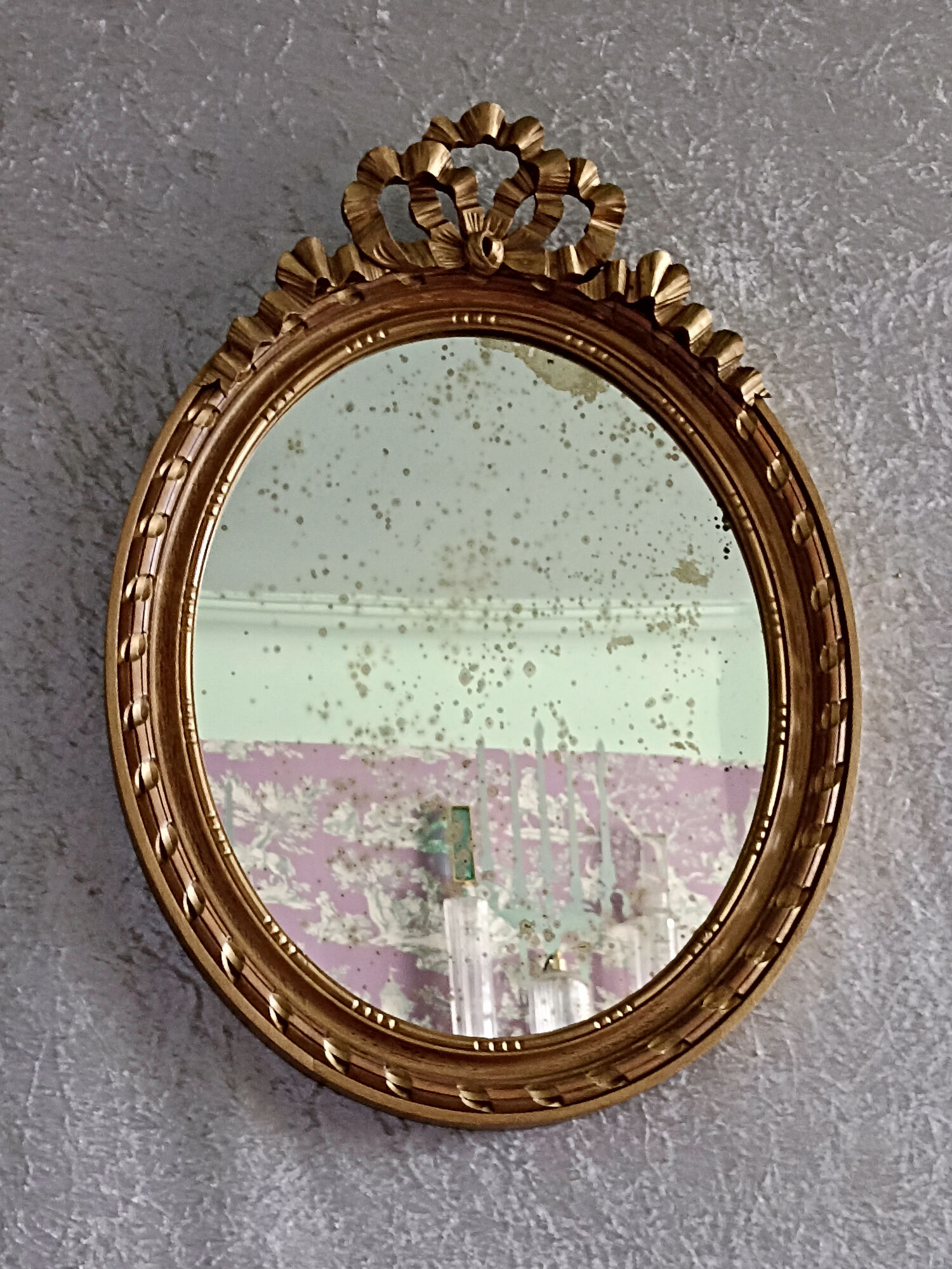 Oval mirror in carved and gilded wood in Louis XVI style