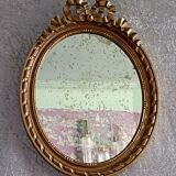Oval mirror in carved and gilded wood in Louis XVI style