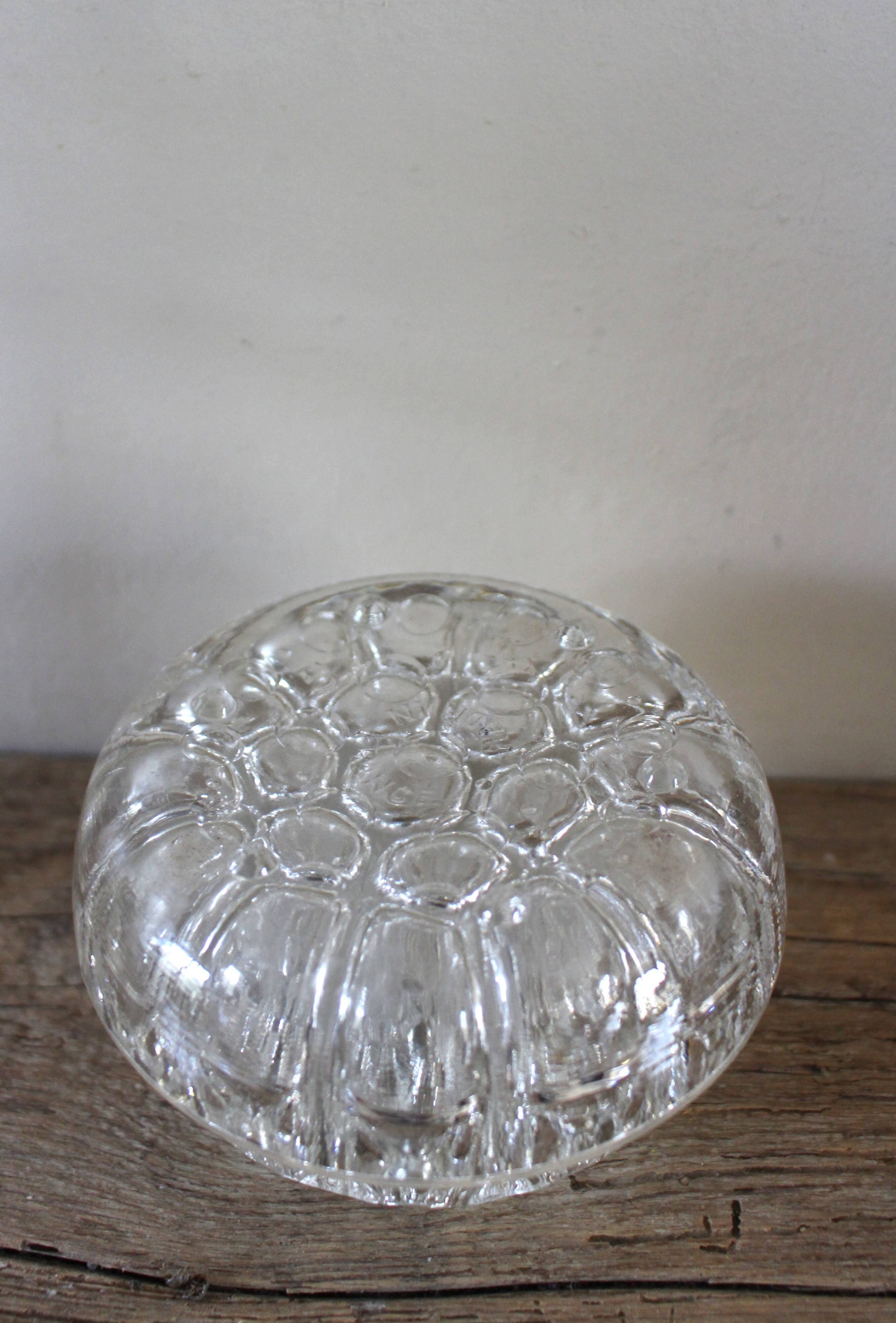 Large round glass flower frog vase with 19 holes.