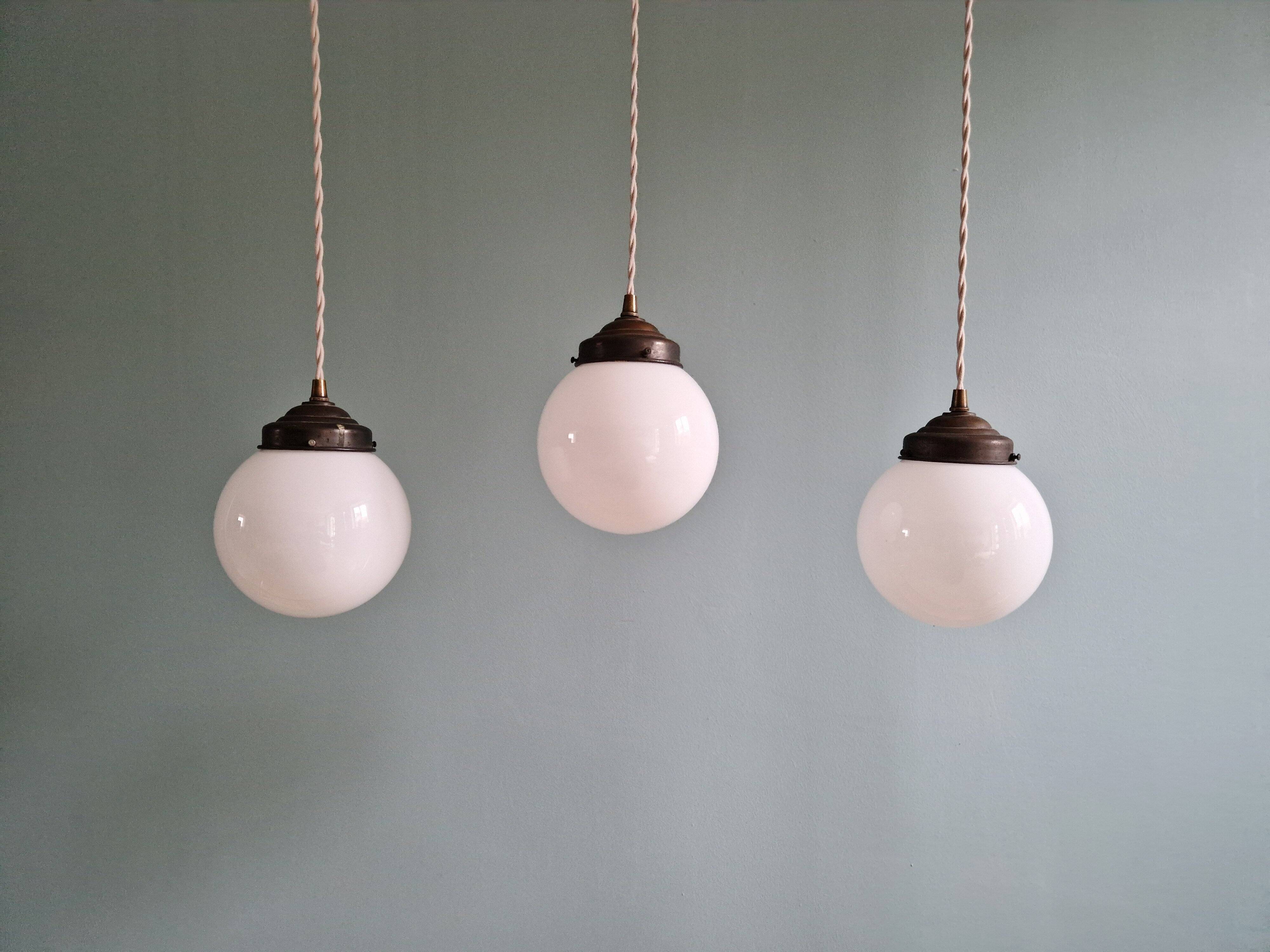 Art Deco trio of suspensions in white opaline, 1930s