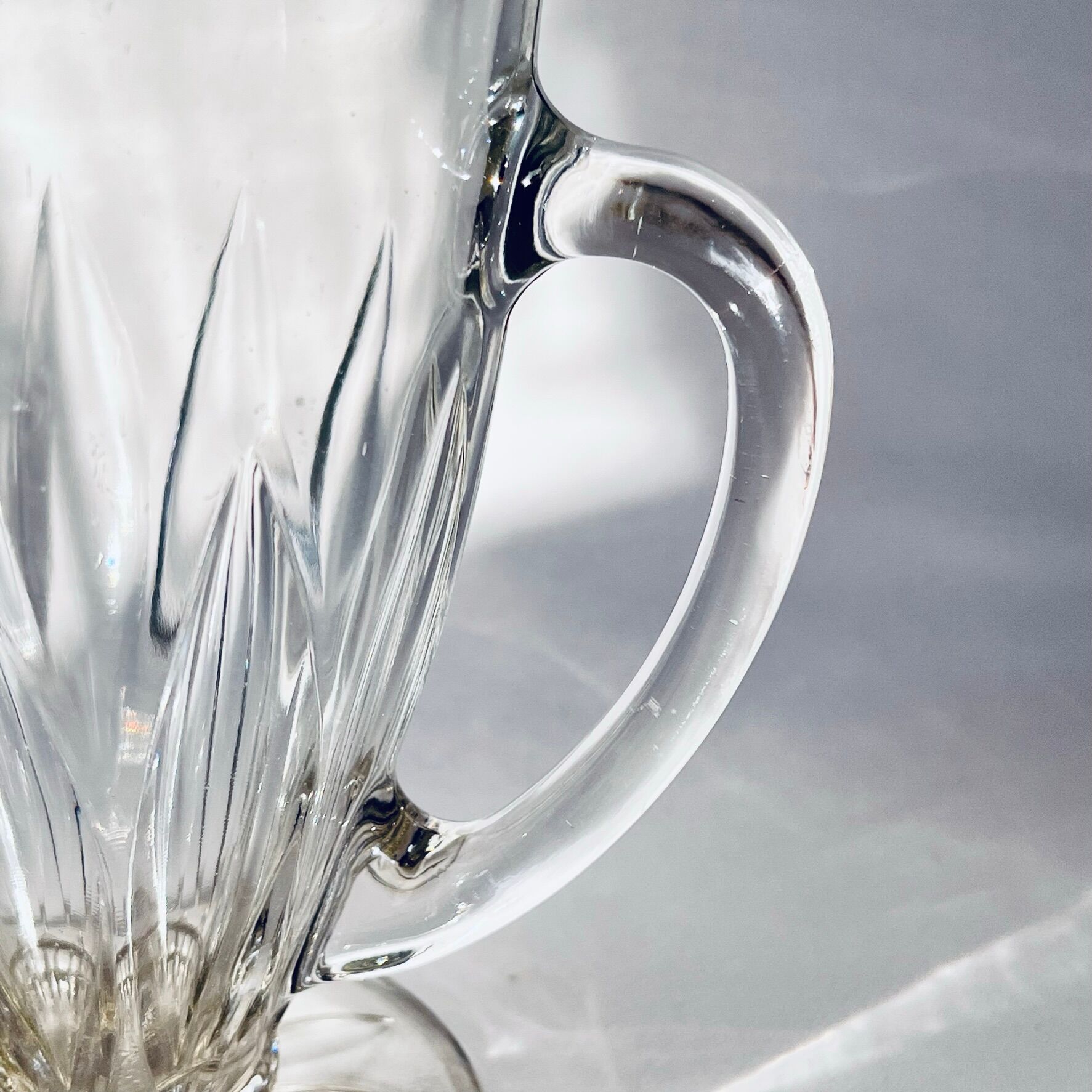 Glass pitcher on base