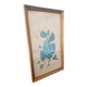 Decorative table with vintage blue flowers in a golden frame.