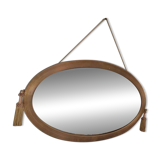 Antique oval beveled mirror adorned with tassels