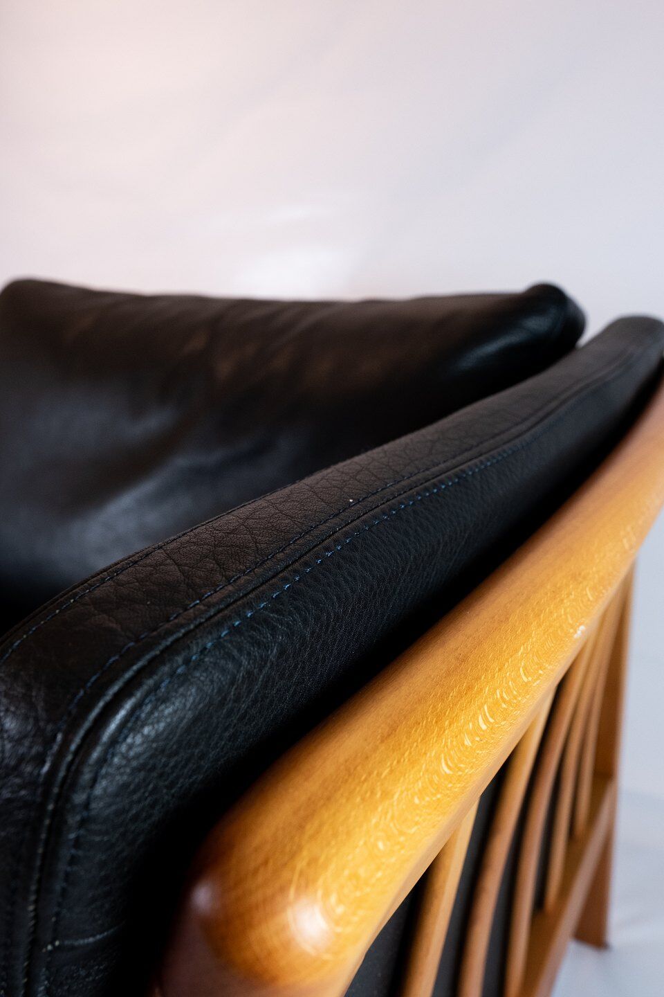 Two seater sofa upholstered with black leather and of danish design