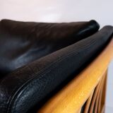 Two seater sofa upholstered with black leather and of danish design
