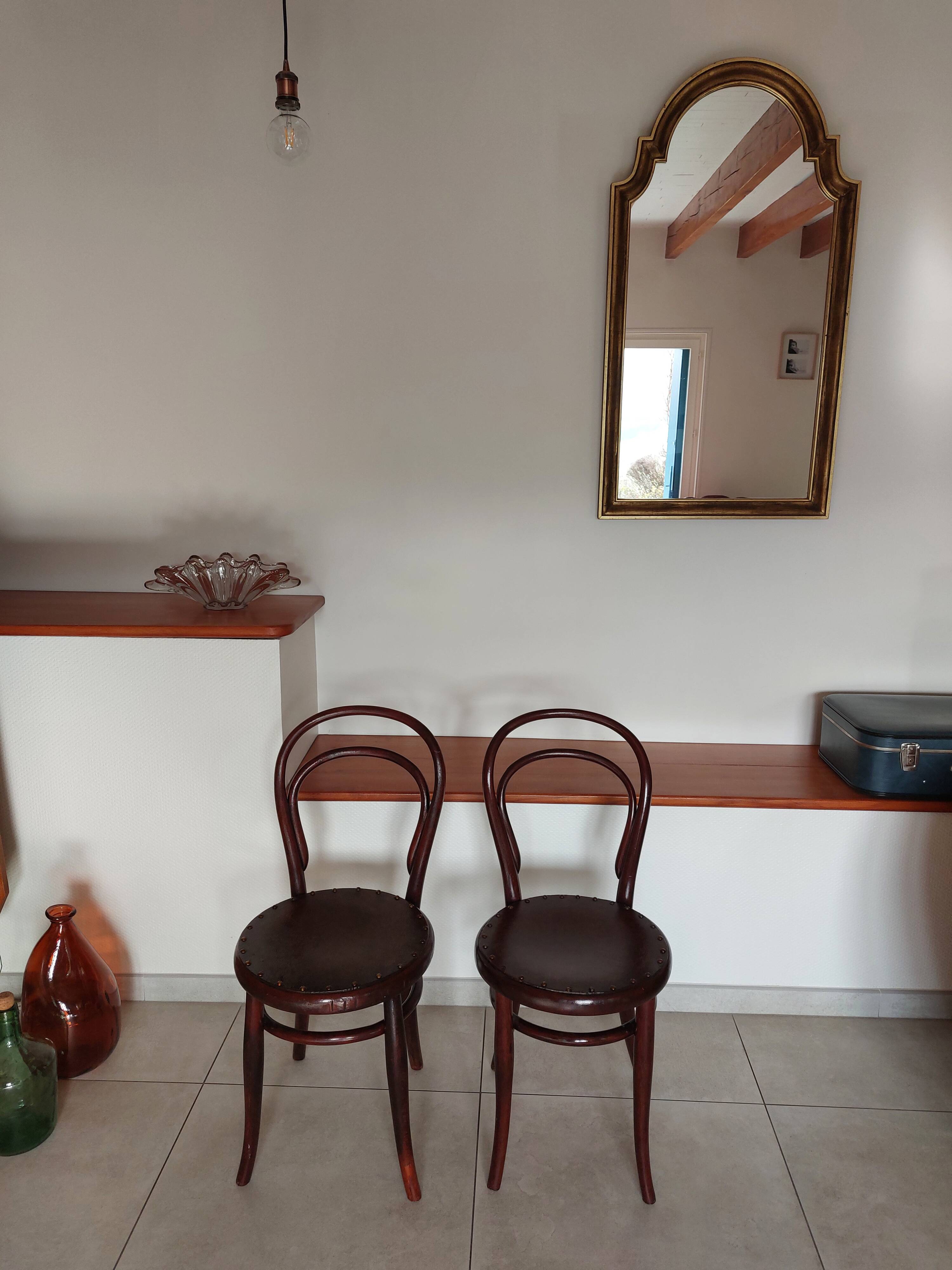 pair of round bistro chairs with a pattern on the seat, vintage