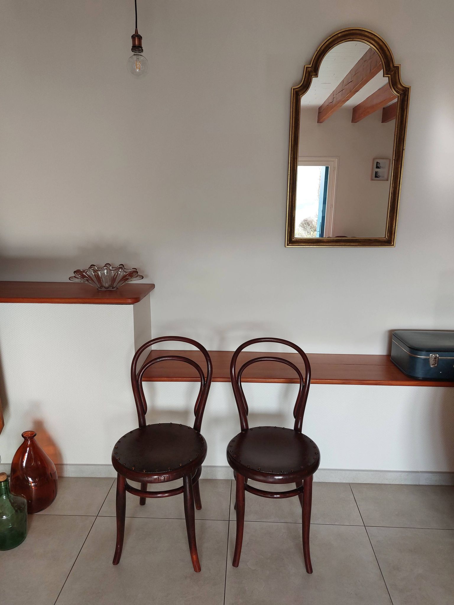 pair of round bistro chairs with a pattern on the seat, vintage