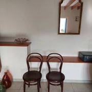 pair of round bistro chairs with a pattern on the seat, vintage