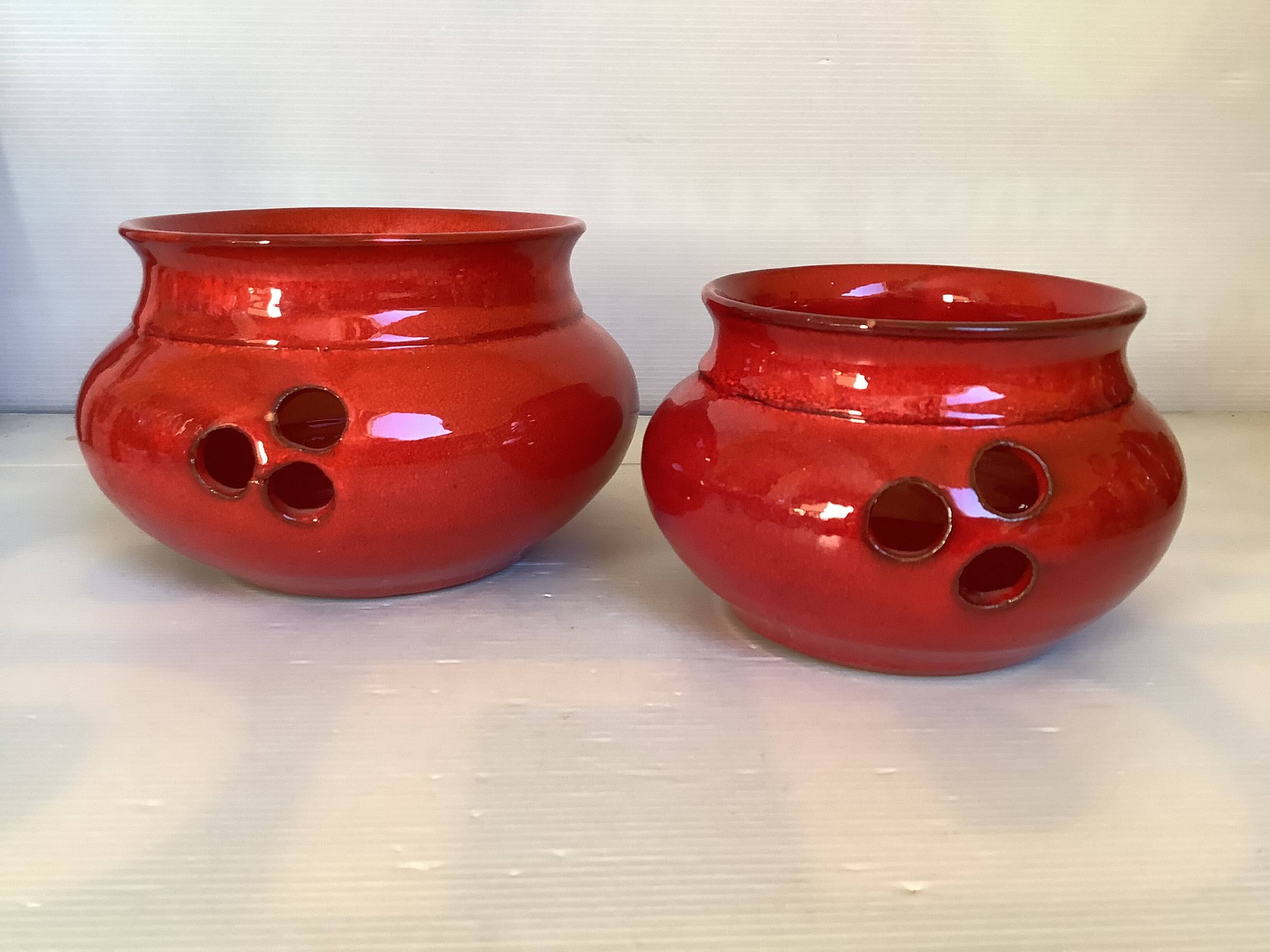 Pair of red Scandinavian candle holders.