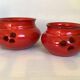 Pair of red Scandinavian candle holders.