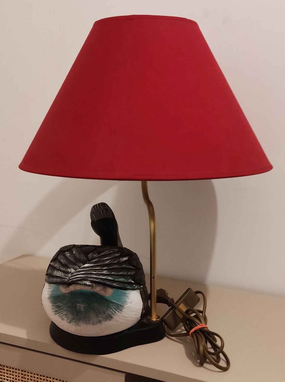 Decorative table lamp with a sculpted duck-shaped base and painted finish.