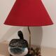 Decorative table lamp with a sculpted duck-shaped base and painted finish.