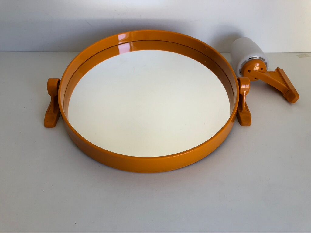 Tiltable orange plastic mirror with matching wall light