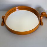 Tilting orange plastic mirror with its matching wall light