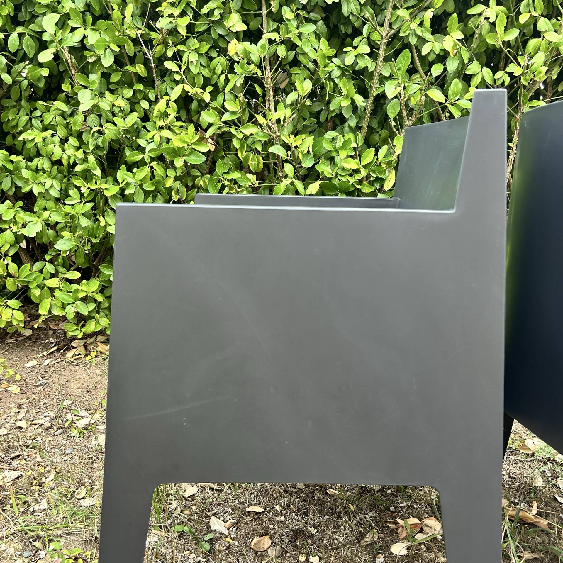 2 black Toy chairs designed by Starck
