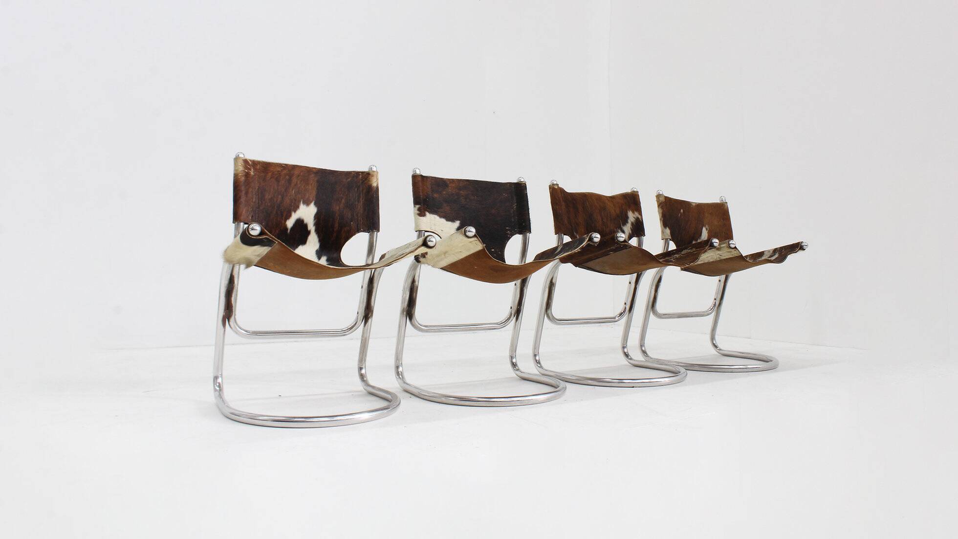 Vintage dining room chairs chrome and cowhide by Parravicini Fratelli