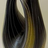 Earthenware vase decorated with yellow lines on a black and yellow background