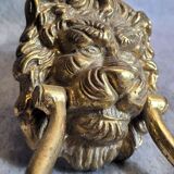 Gilded bronze door knocker in the shape of a lion's head