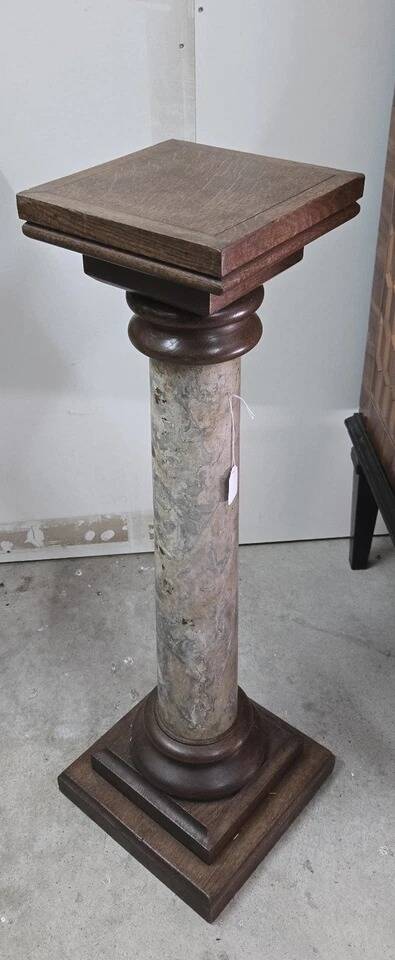 Column-shaped pedestal, made of solid wood and faux marble paint.